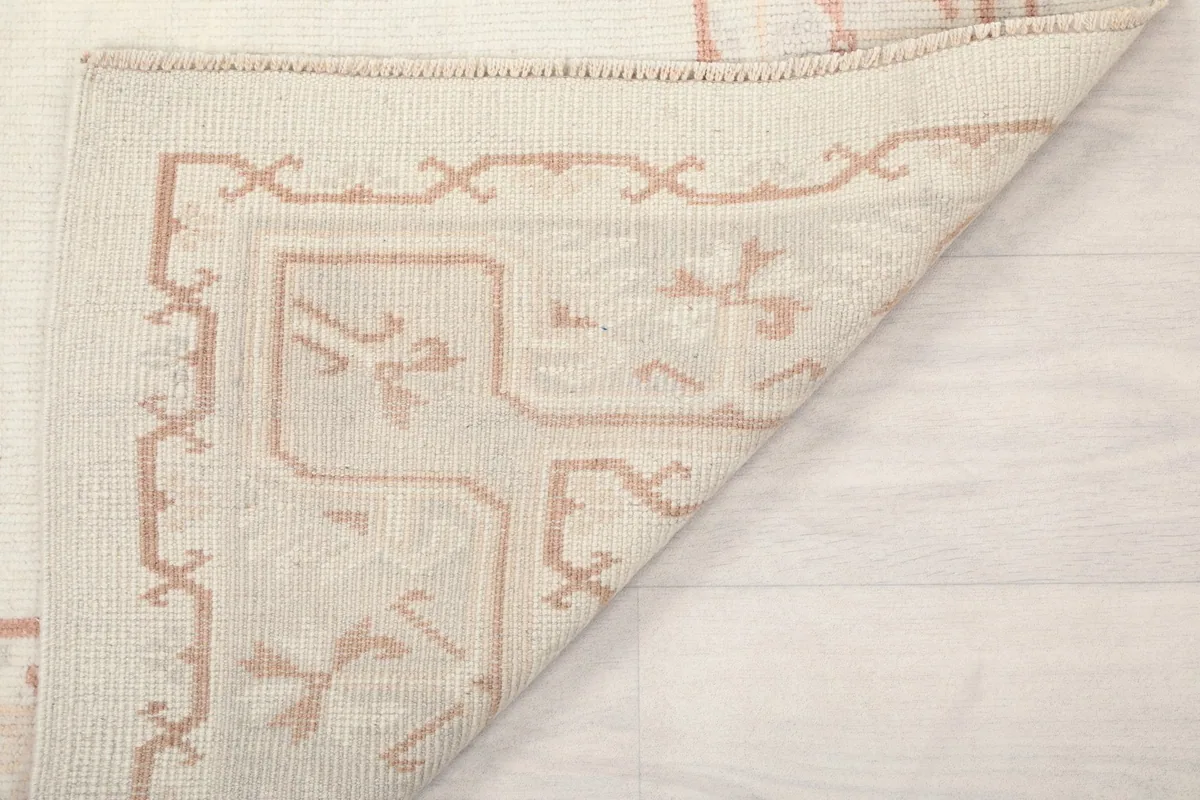 Another view of the rug corner folded, showing the hand-knotted wool on cotton foundation