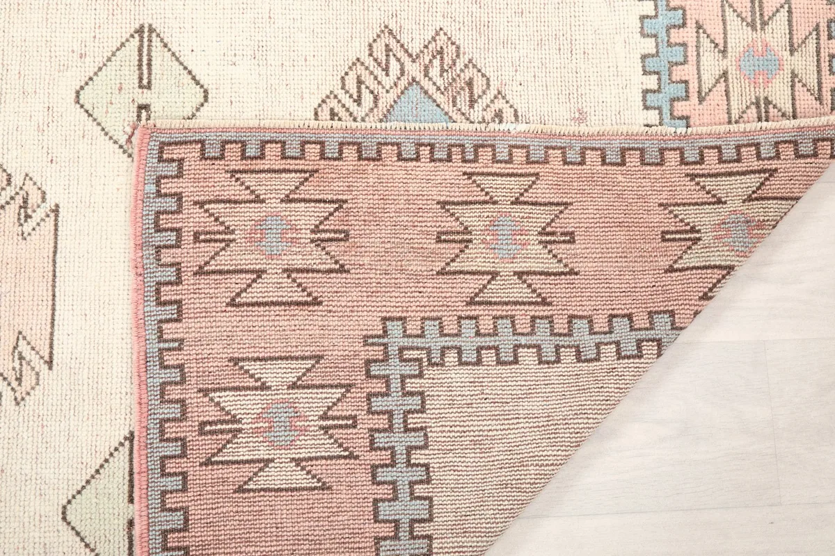 Reverse side of the rug's corner, showing the tight hand-knotted weave and foundation