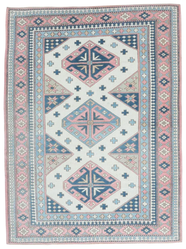 Full top view of the 5'11" x 8'0" vintage Anatolian rug with ivory, pink, and blue geometric patterns