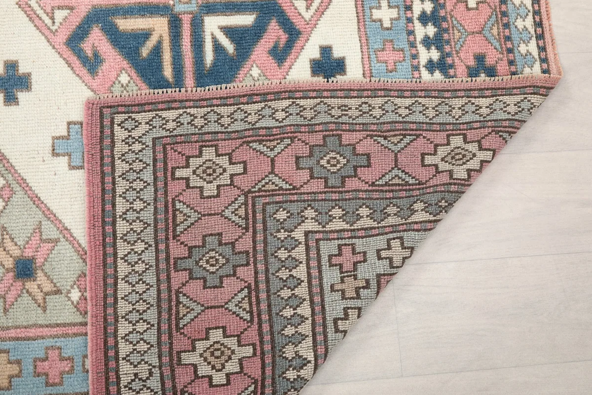 Close-up of the rug's corner with the back visible, showing the hand-knotted construction