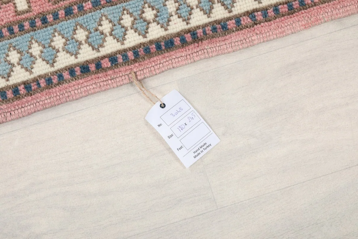 Product tag attached to the rug, displaying size and origin information