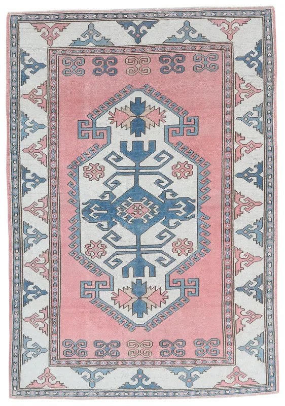 Full top view of the vintage Anatolian rose and blue geometric area rug on a white background