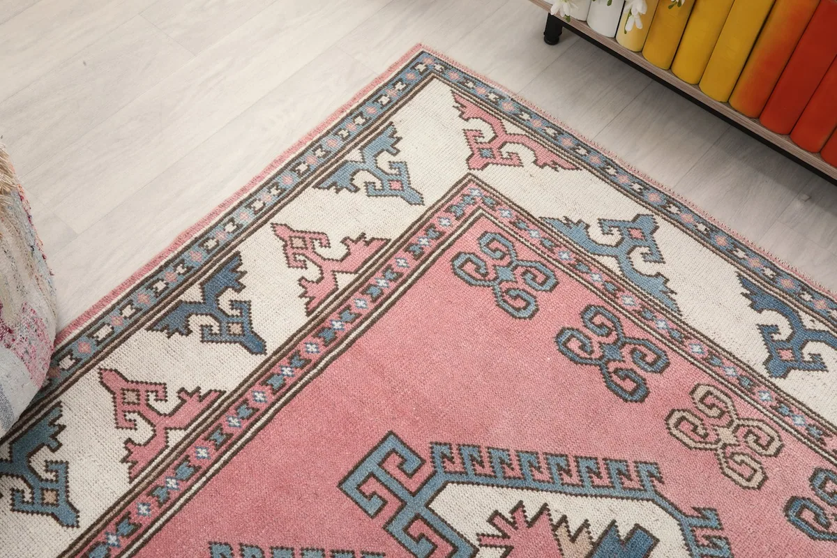 Overhead angle highlighting the rug's border design and the geometric motifs at the top corner
