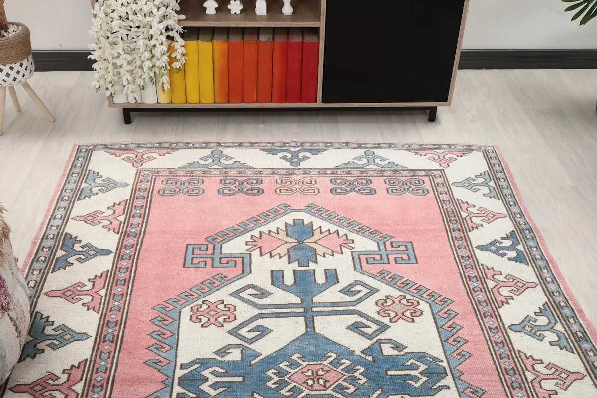 Straight-on view of the rug placed in a room, showing its full design and colors