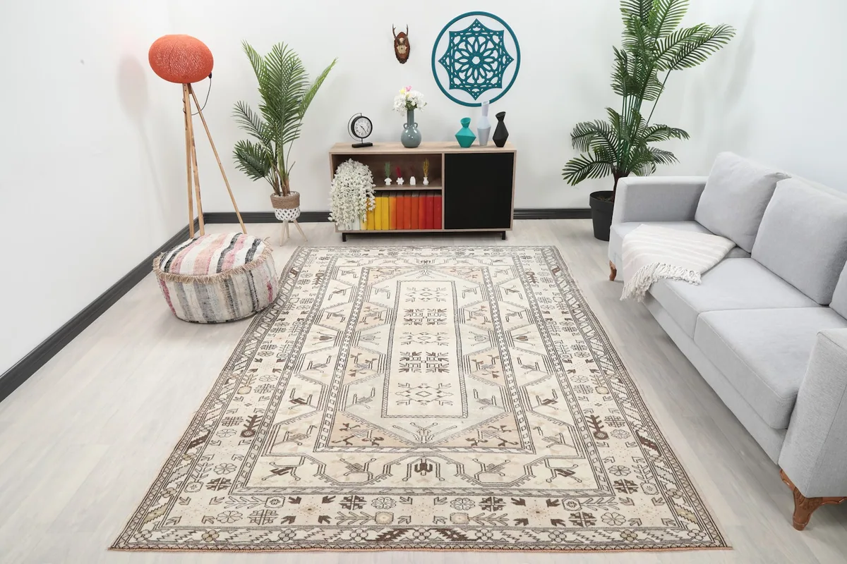 Vintage Anatolian rug displayed in a living room setting with a light gray couch