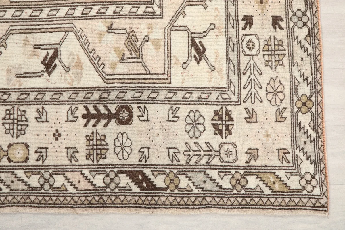Detailed view of the border and corner motifs, showcasing brown and gray patterns