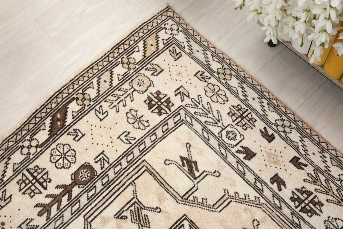 Corner detail of the rug, illustrating the intricate floral and geometric border elements