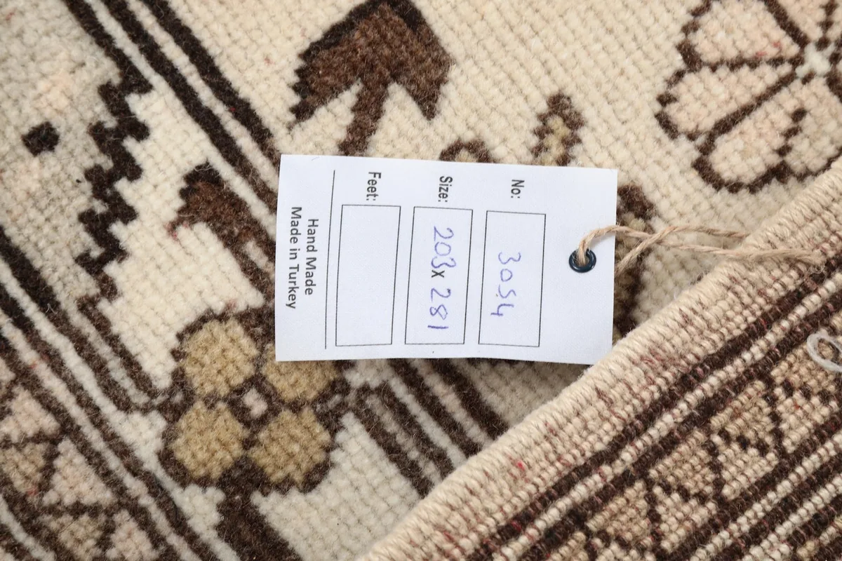 View of the rug's reverse side with a tag showing its origin and dimensions