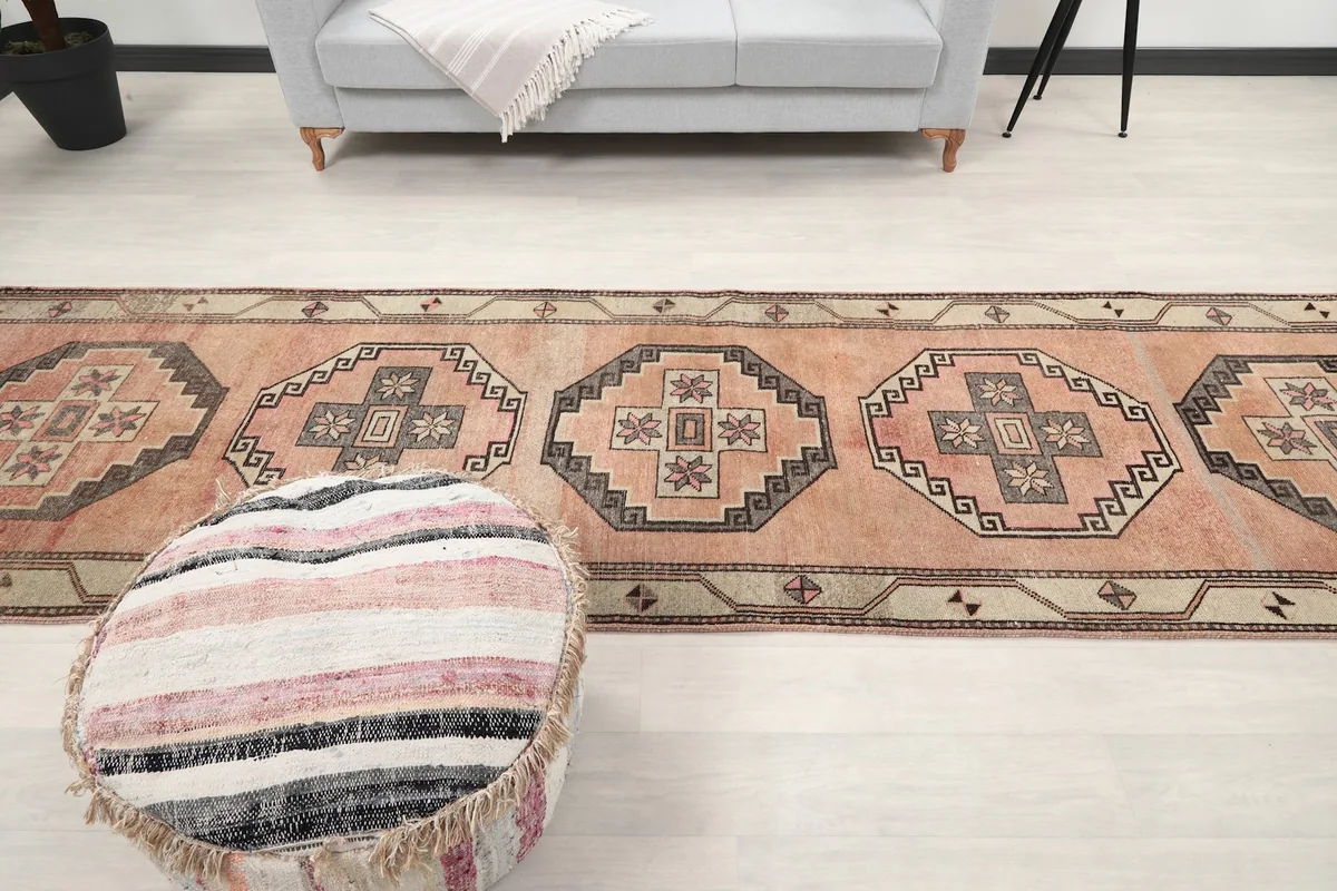 View of the runner rug from the other end, showcasing its full length in the room.