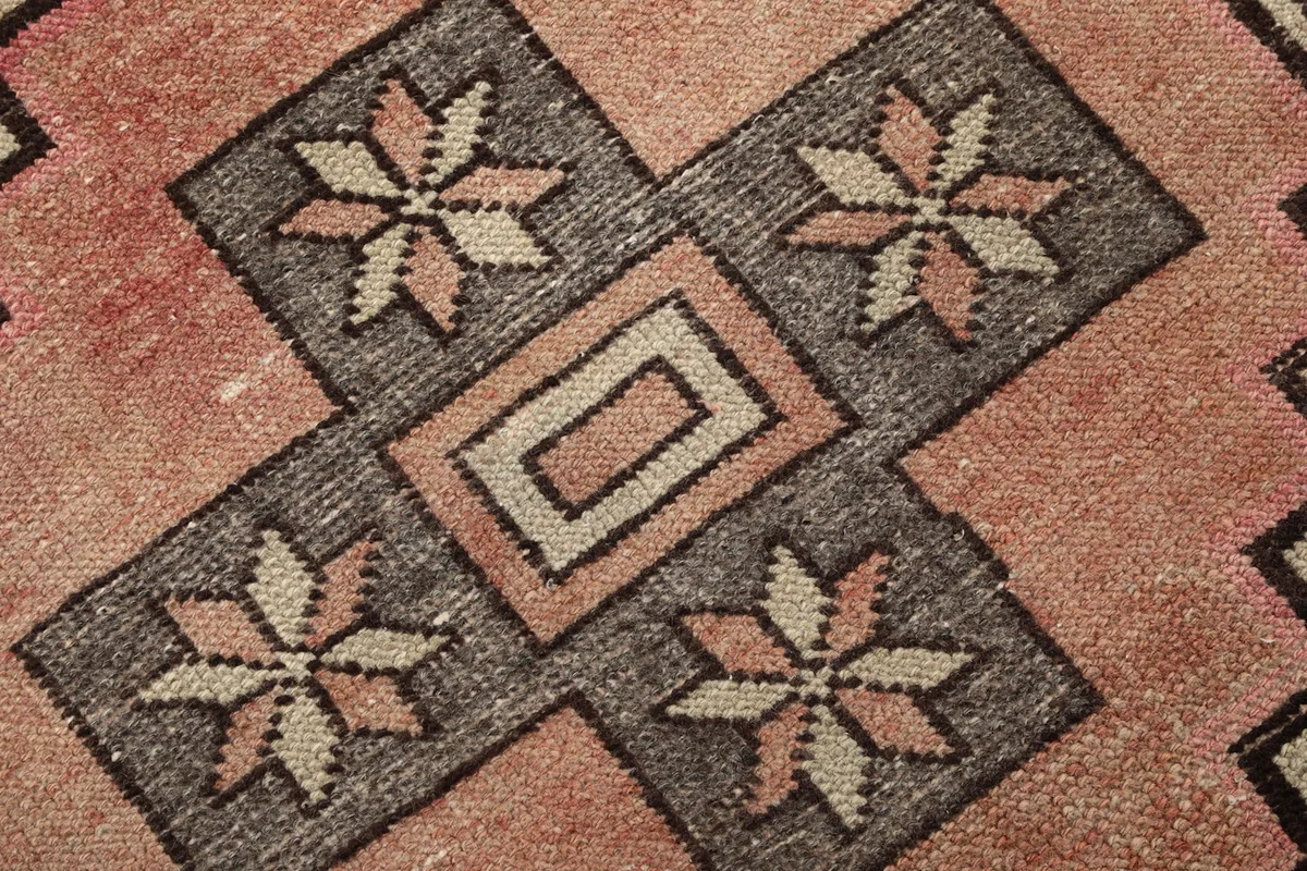 Macro detail of the hand-knotted wool pile, showing colors and texture within a medallion.