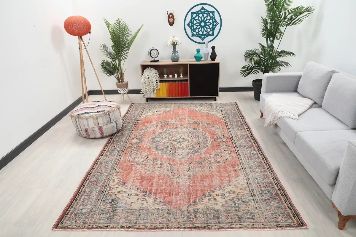 Vintage rose and gray Anatolian rug displayed in a modern living room setting