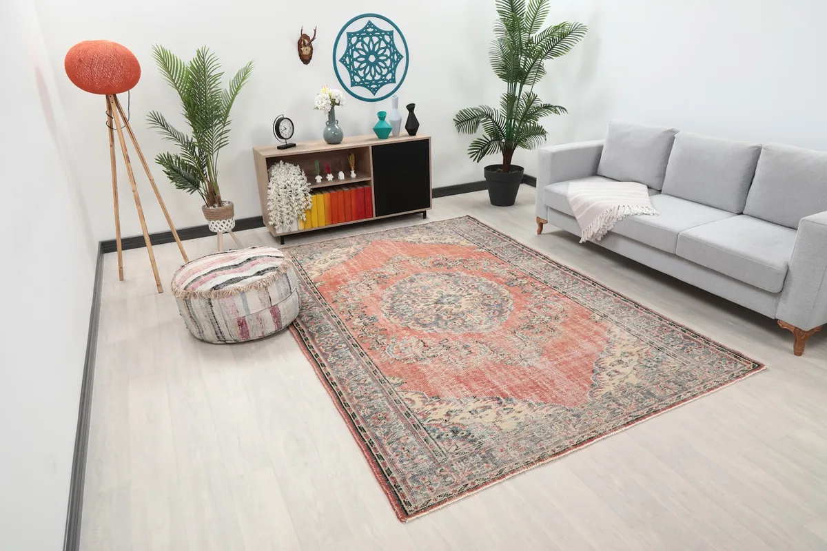 Angle view of the hand-knotted rug in a room, showing its medium size and colors