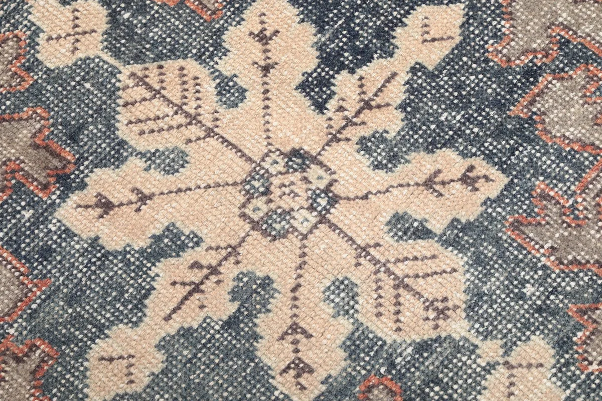 Close-up of the central snowflake-like motif in navy and ivory