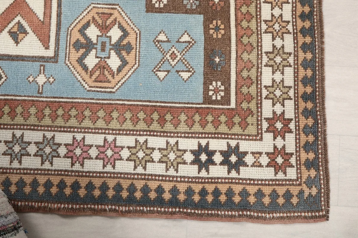 Detailed view of the rug's corner showcasing the intricate border patterns and colors