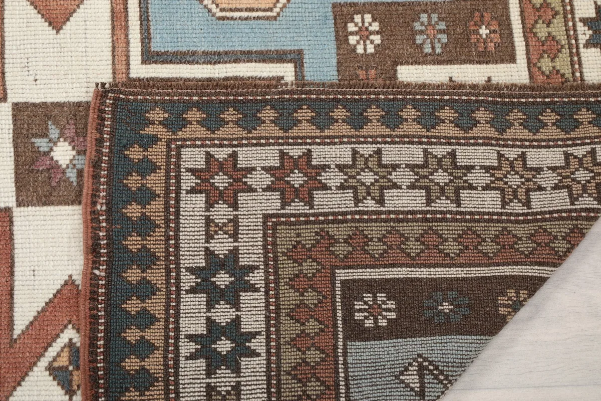 Underside view of the rug, showing the cotton foundation and the reverse of the knotting