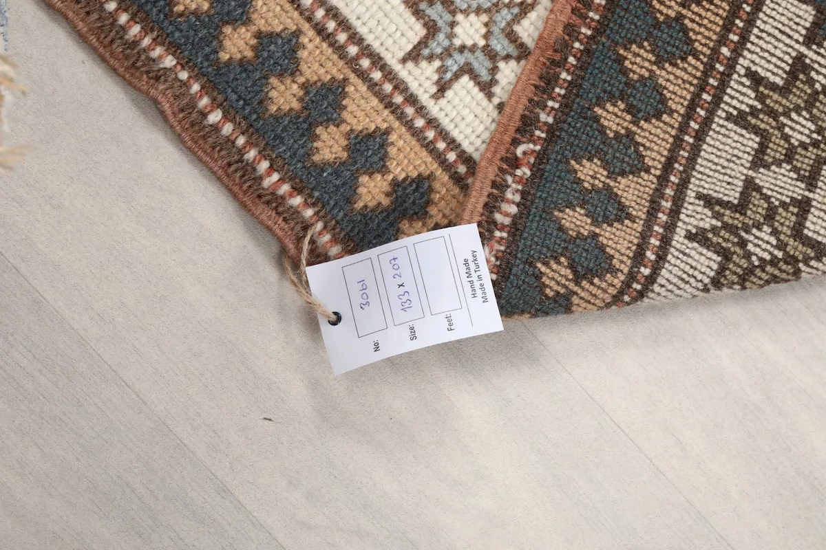 Close-up of the rug's edge and care tag, indicating its size and material