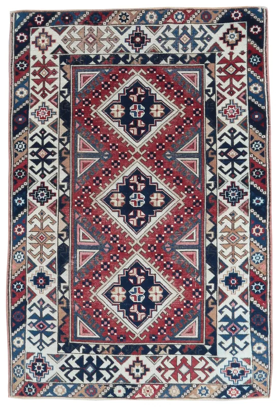 Full top view of the vintage Anatolian rug with red, navy, and ivory geometric patterns