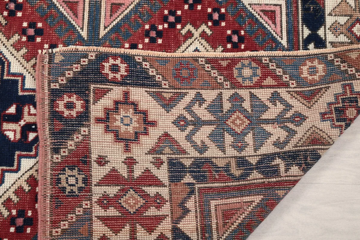 Underside view of the hand-knotted rug, showing the reverse of the patterns and foundation