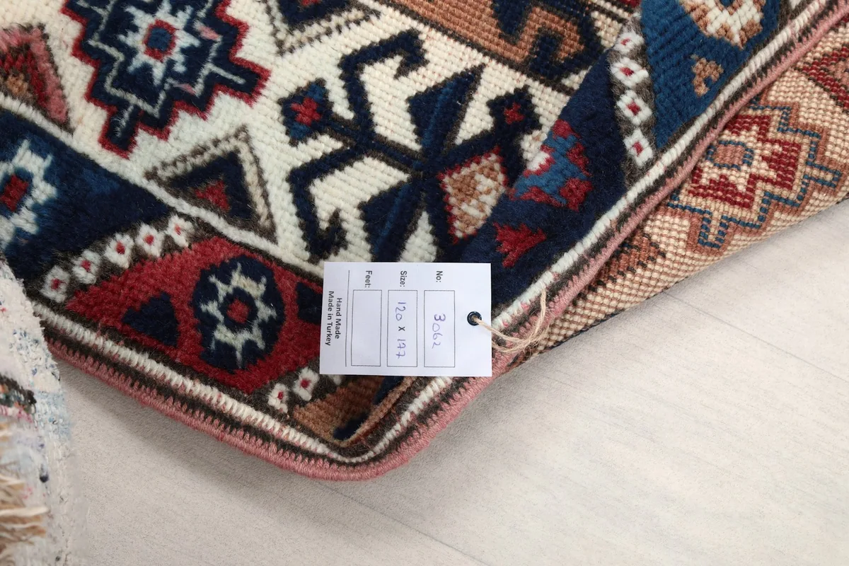 Close-up of the rug's back with a tag indicating its origin and dimensions