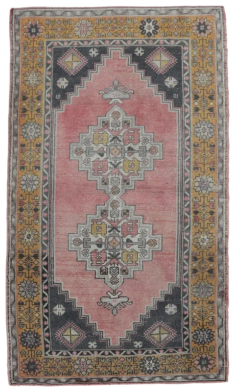 Full top view of the vintage rose, gold, and navy geometric rug on a white background.
