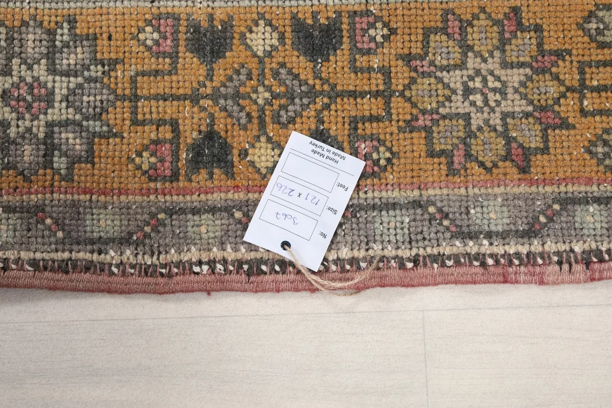 Close-up of the rug's edge with a product tag, indicating its origin and material.
