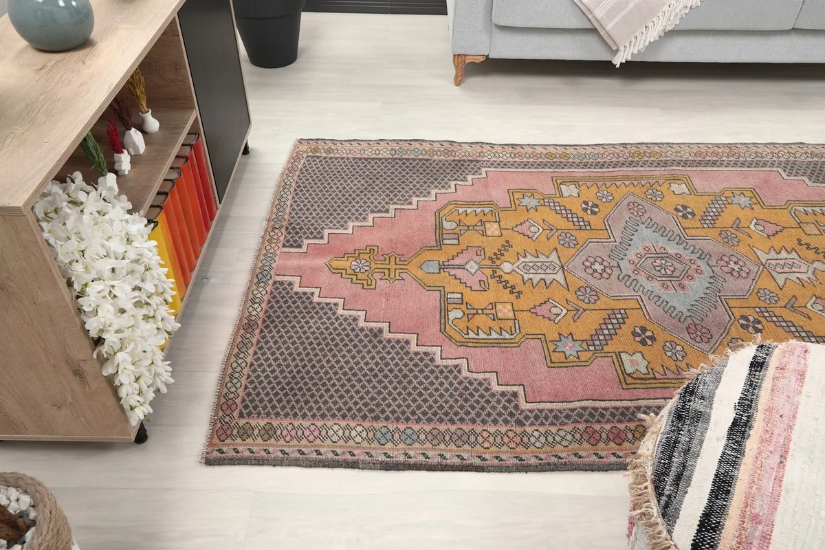 Wide shot of the rug in a living room, showcasing its medium size and design