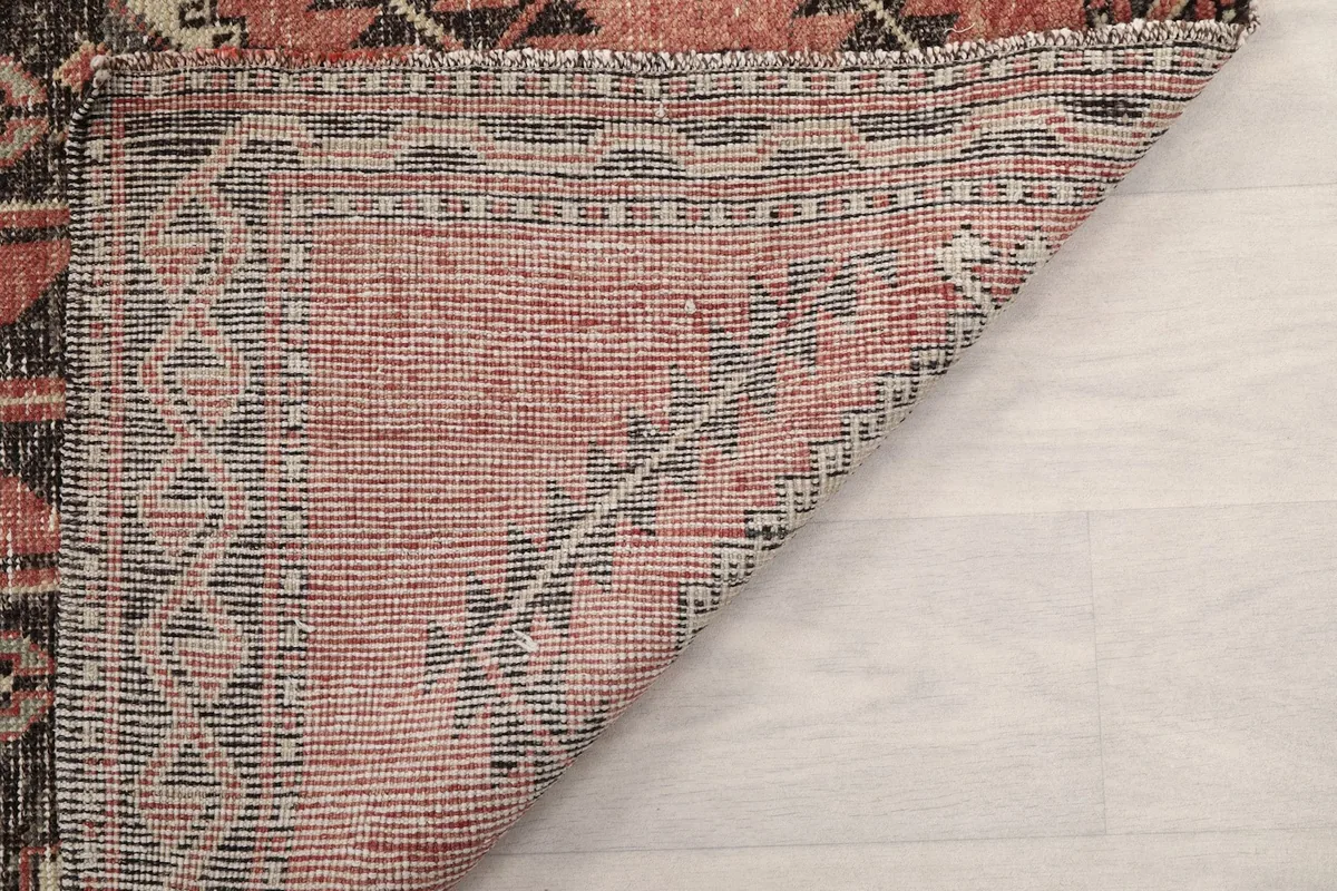 Close-up of the low pile and hand-knotted texture of the vintage Anatolian wool rug