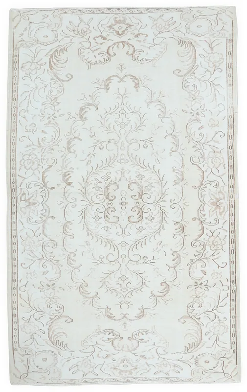 Full overhead view of the 5'5" x 9'1" ivory and tan vintage Anatolian area rug