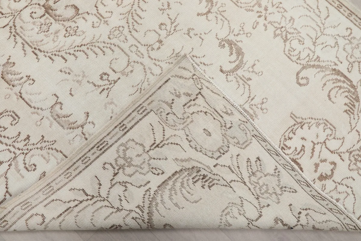 View of the back of the rug, showing the hand-knotted cotton foundation and wool pile