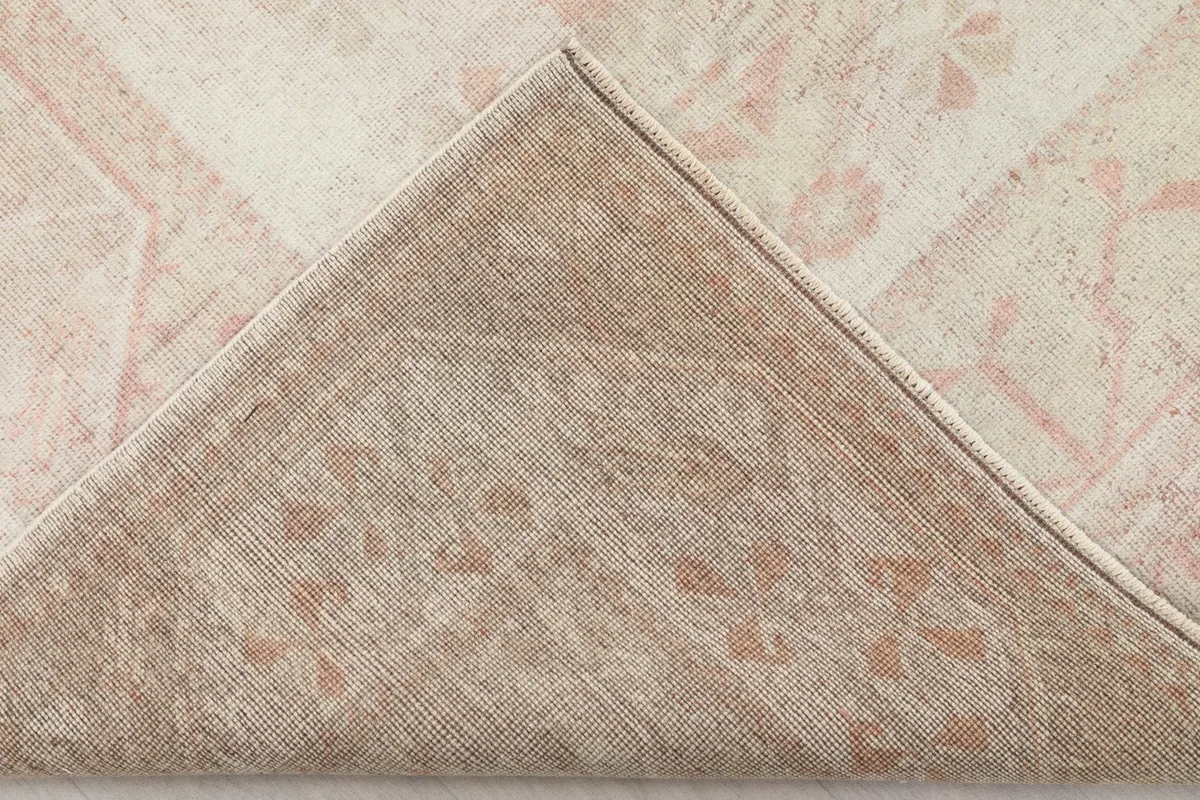 Underside view of the rug, showing the cotton foundation and hand-knotted construction