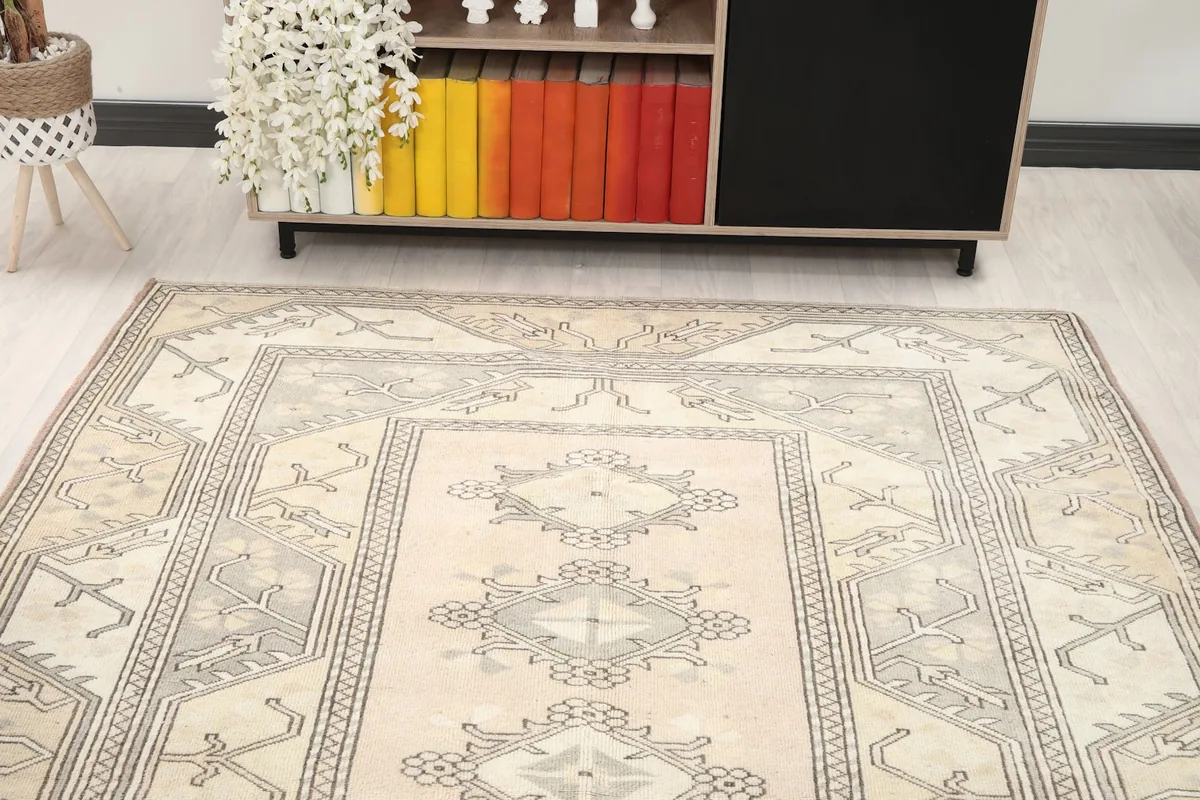 Angled view highlighting the rug's geometric patterns and muted colors