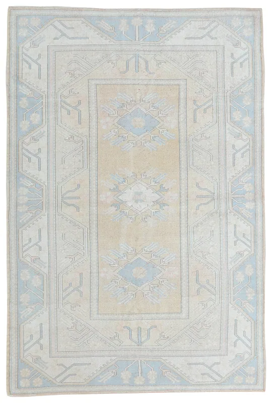 Full overhead view of the beige and blue hand-knotted vintage Anatolian area rug