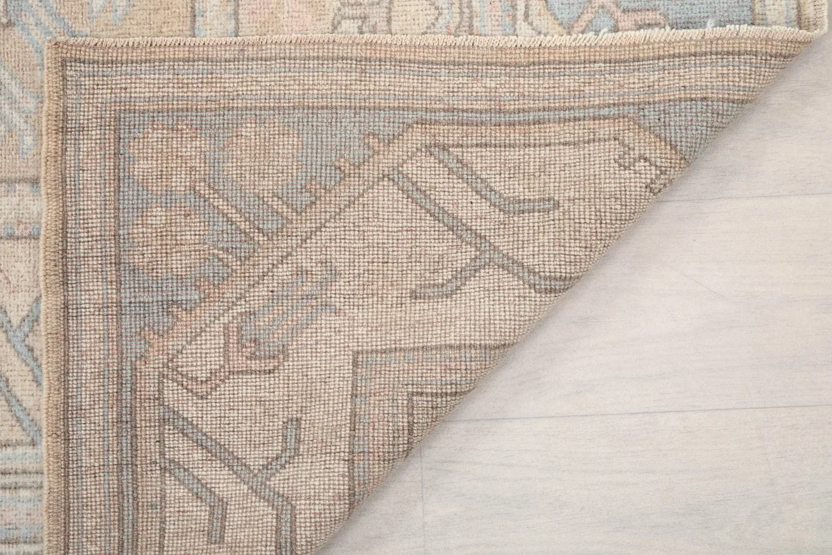 Another view of the rug's reverse side, showing the tightly woven knots and material