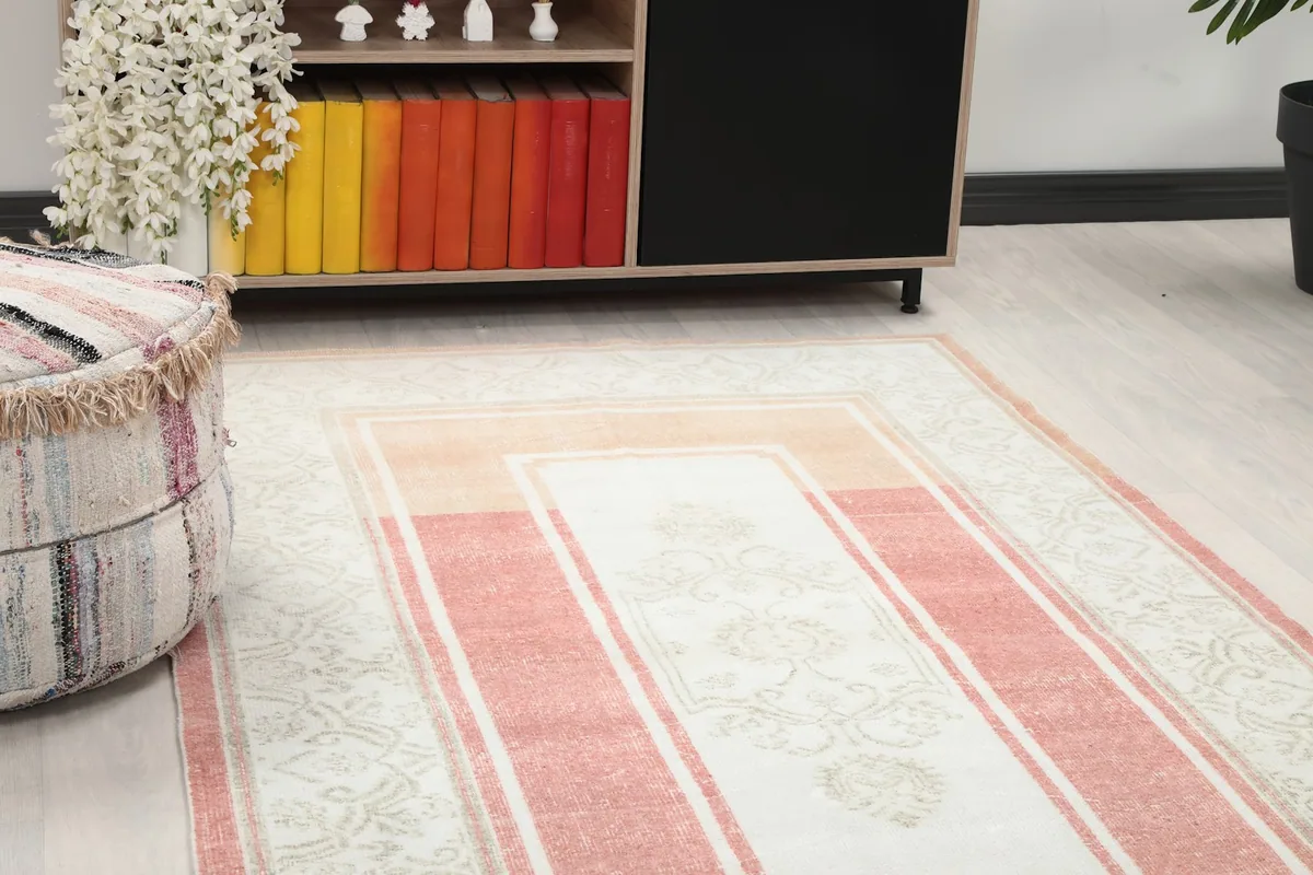 Close-up view of the rug's central panel and a corner border, showing the subtle color variations and motifs.