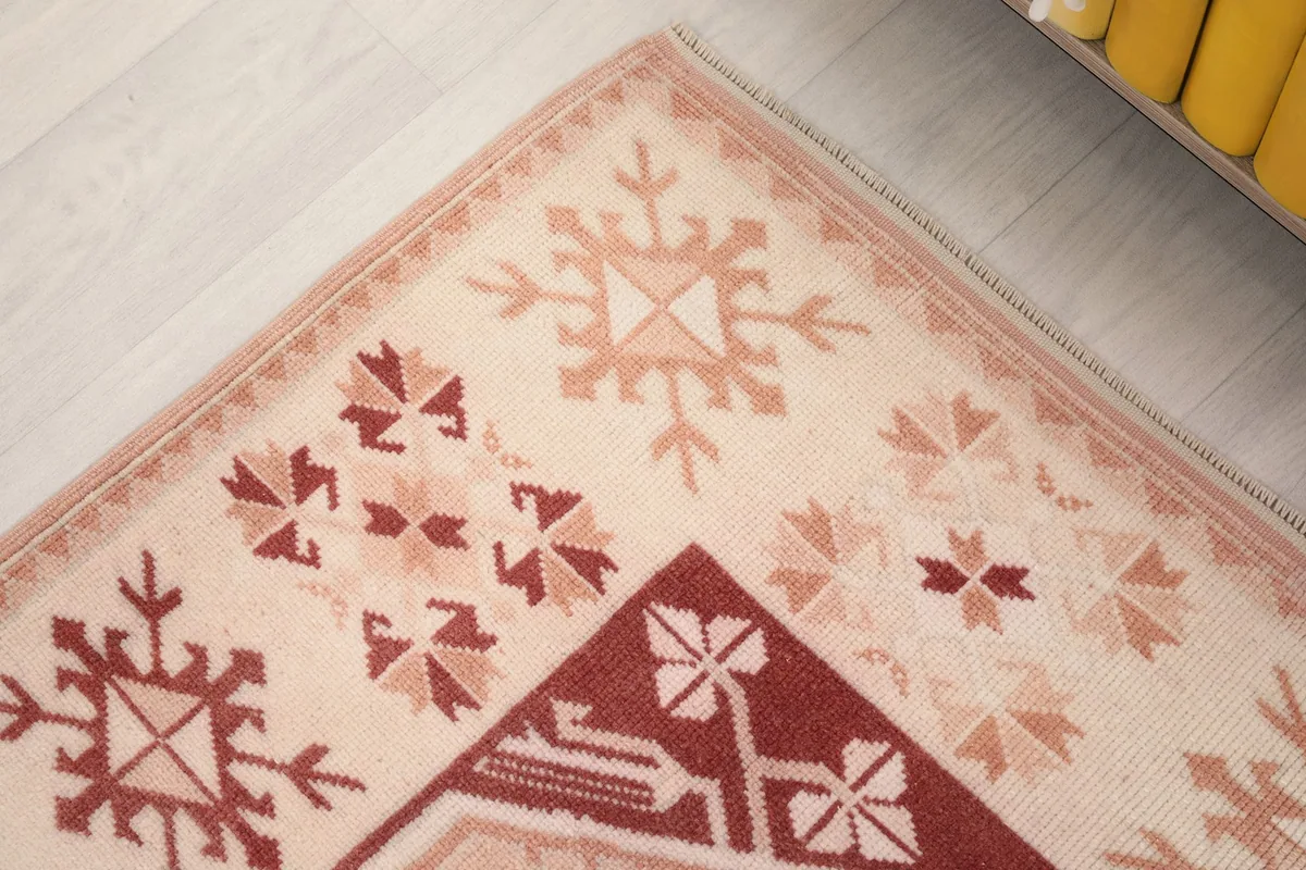Detailed view of the corner motif, featuring rust and rose geometric shapes