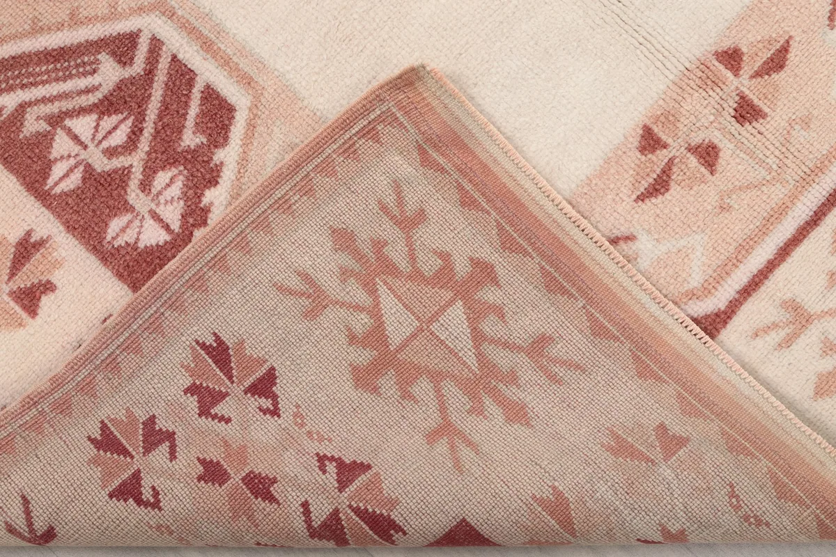 Folded corner of the rug, revealing the reverse side of the hand-knotted wool and cotton foundation