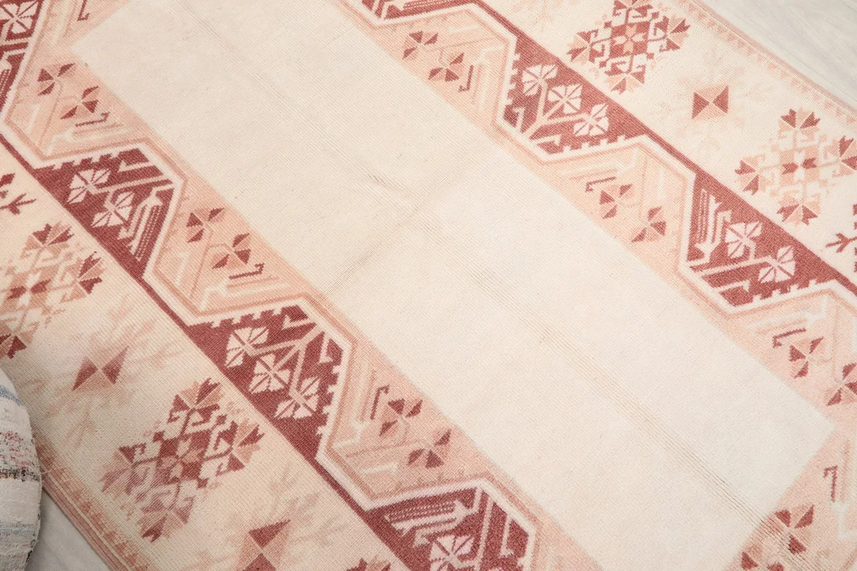 Overhead view highlighting the central ivory panel and the detailed rust geometric patterns