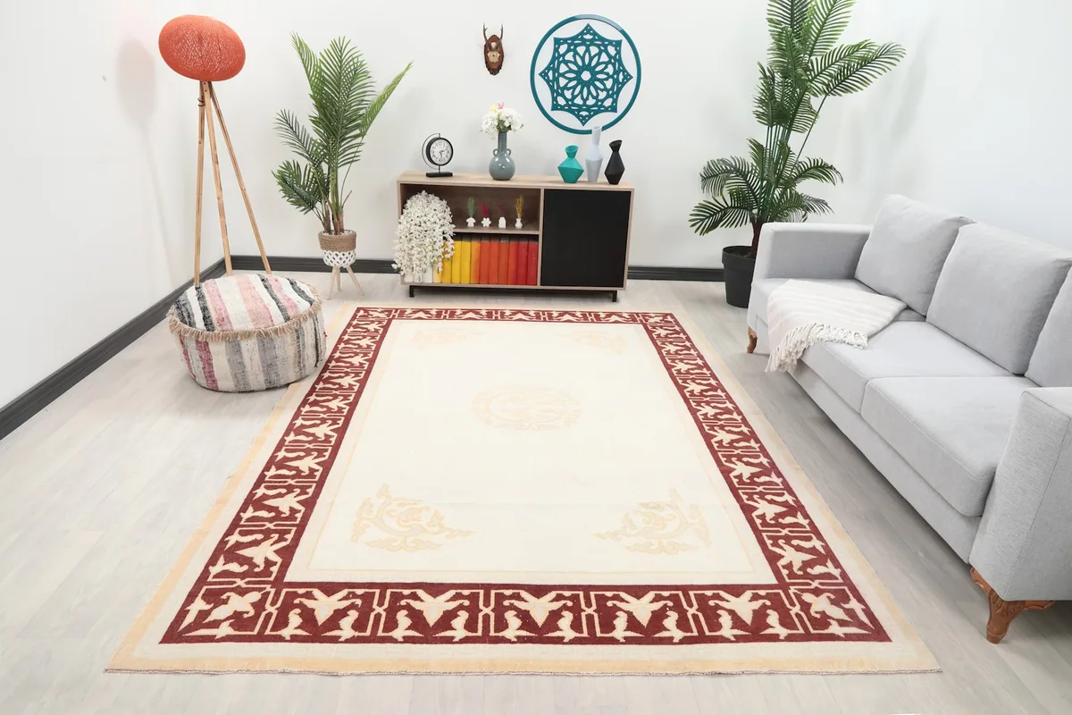 Vintage Anatolian rug displayed in a living room setting with a sofa and plants