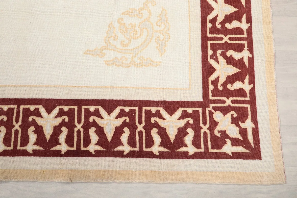 Detailed view of a corner motif and the intricate geometric border pattern