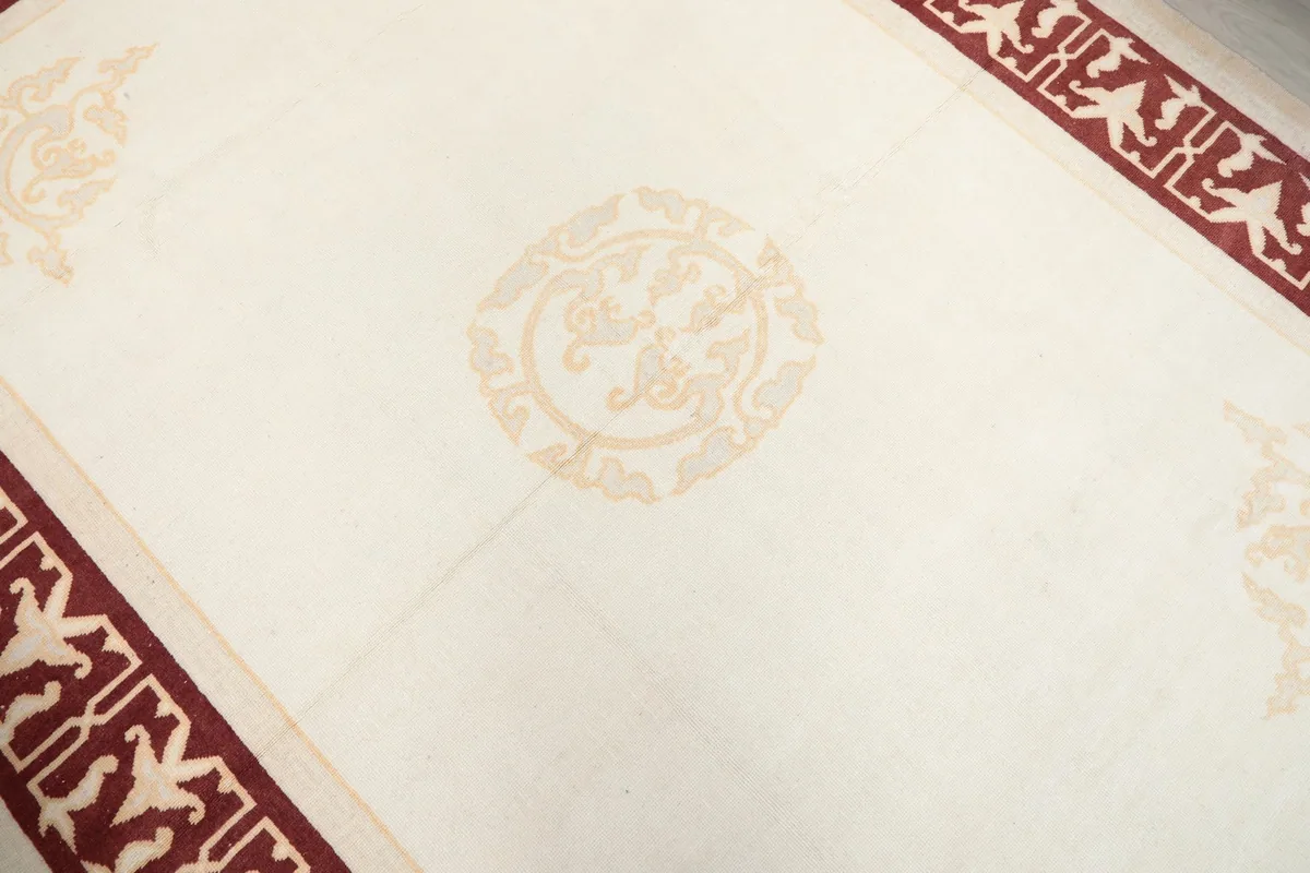 Close-up of the central medallion motif on the ivory field