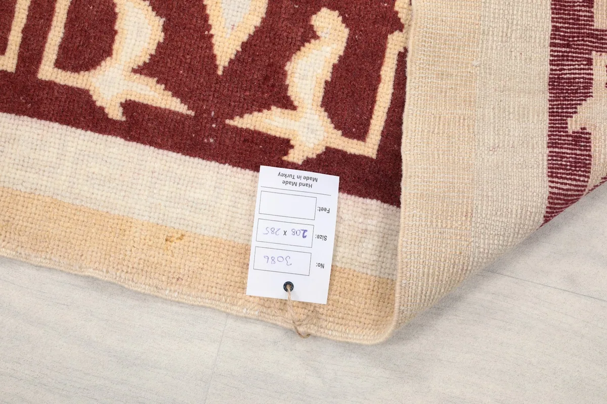 Close-up of the back of the rug with a tag, showing the knotting and foundation