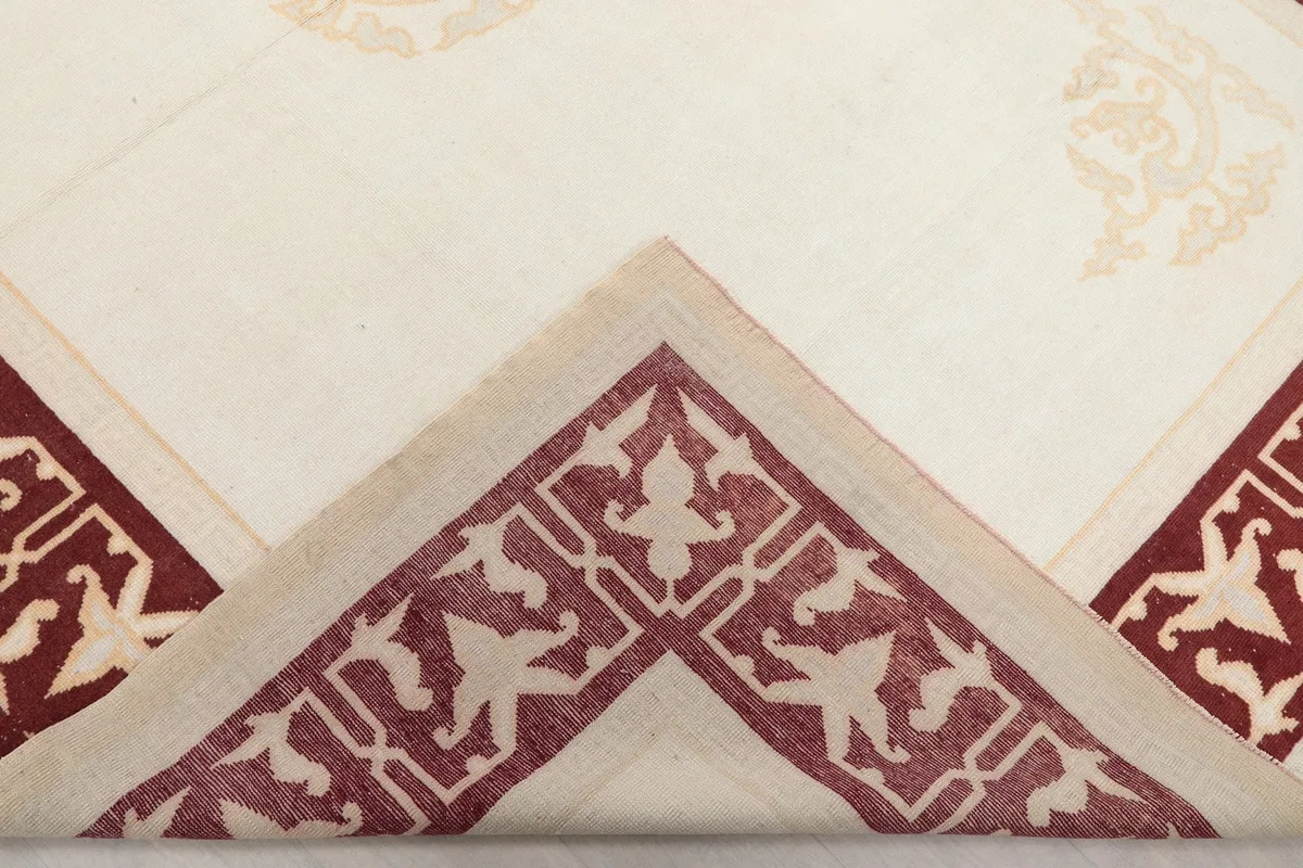 Folded corner of the rug, showing the hand-knotted wool pile and cotton foundation