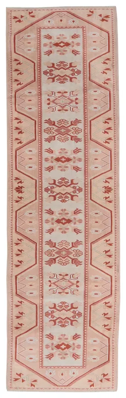 Full overhead view of the vintage Anatolian runner rug with cream and rose geometric patterns