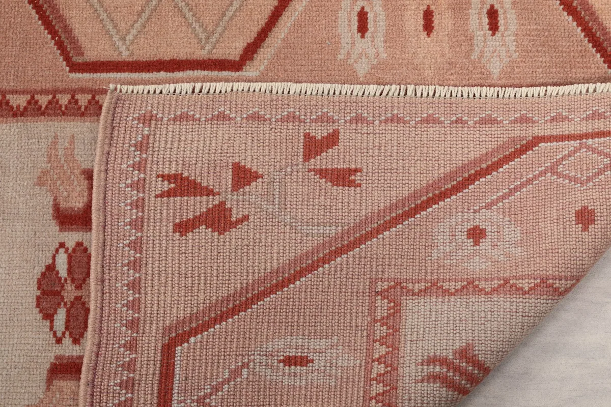 Underside of the rug, showing the hand-knotted cotton foundation and the reverse of the pile