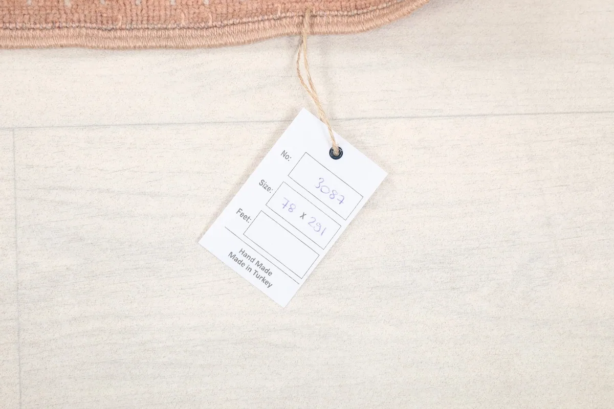 Product tag displaying the rug's size and origin, confirming it is hand-made in Turkey