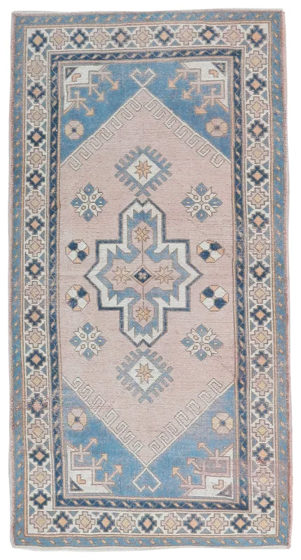 Full top view of the vintage pink and blue Anatolian rug on a white background.