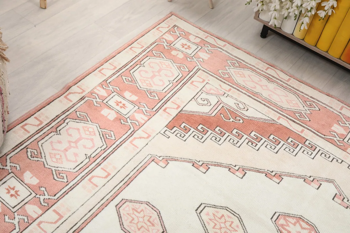 Angled view highlighting a corner of the rug, showing border and field details