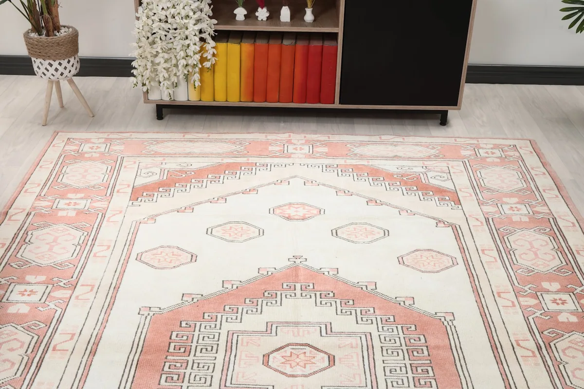 Overhead view of the rug in a room, focusing on the top half of the design