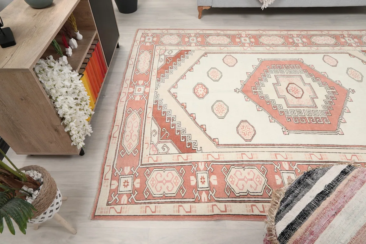 Overhead view of the rug in a room, focusing on the bottom half and surrounding decor