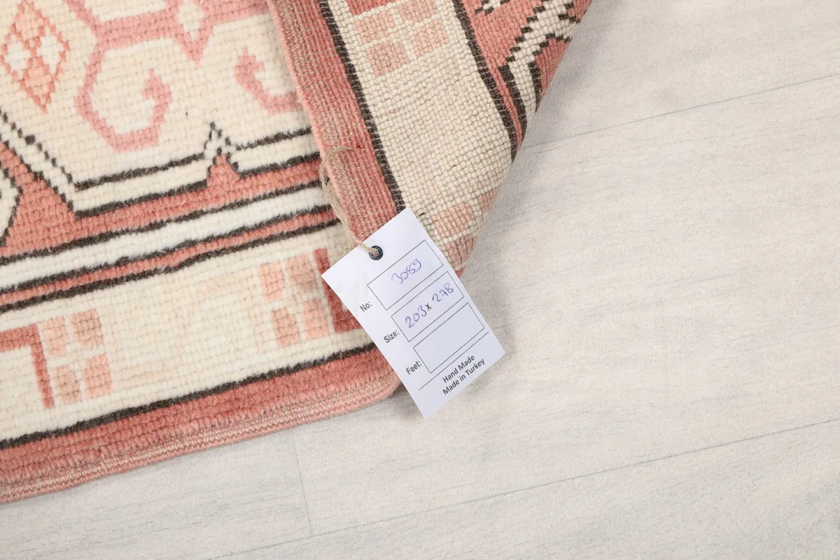 Close-up of the rug's reverse side showing the care tag and knotting structure